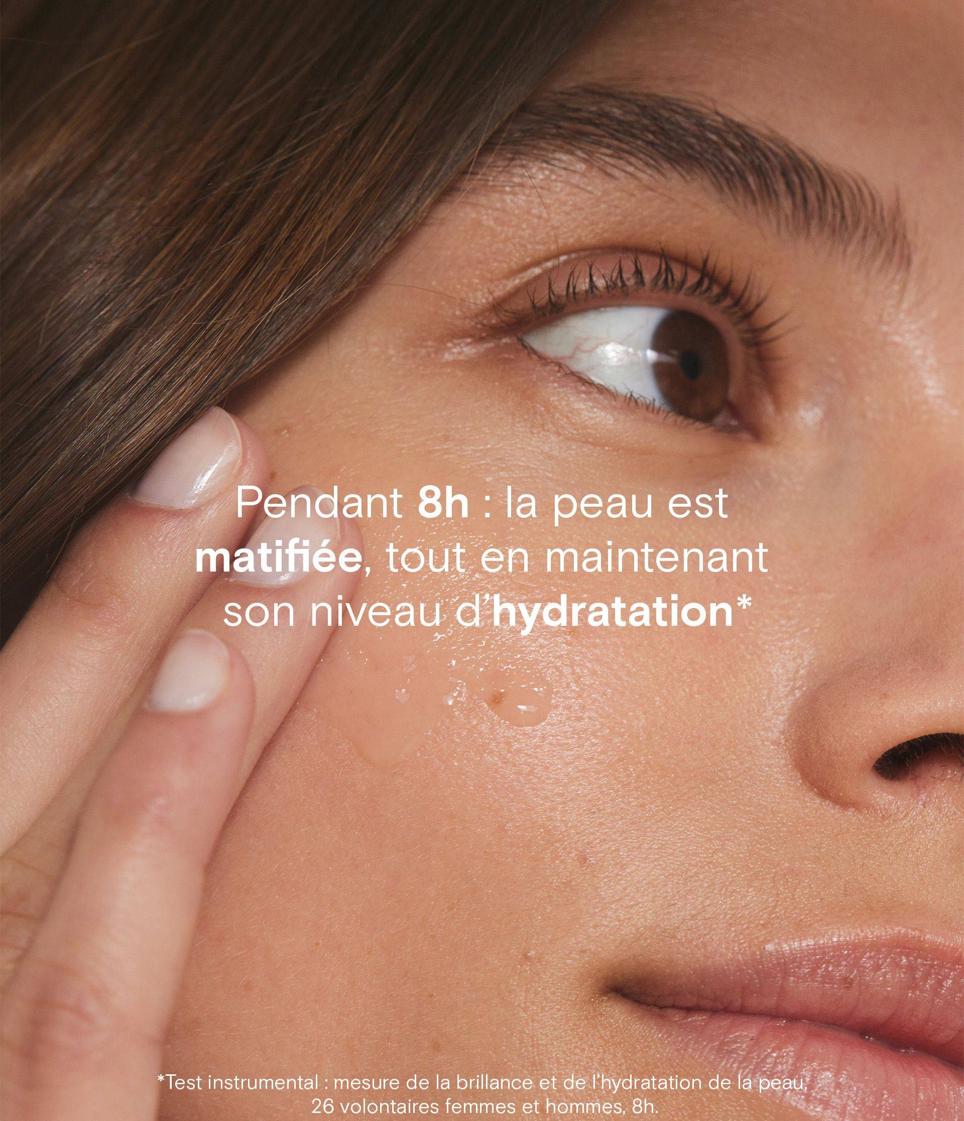 Close-up of a person applying skincare product on their cheek with marketing text about hydration and mattifying effects lasting 8 hours.
